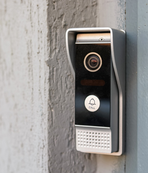 access control panel at front door with integrated camera